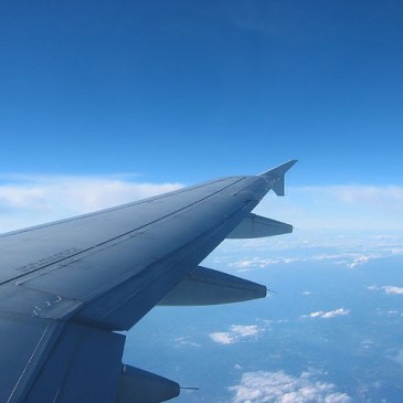 Plane wing over clouds
